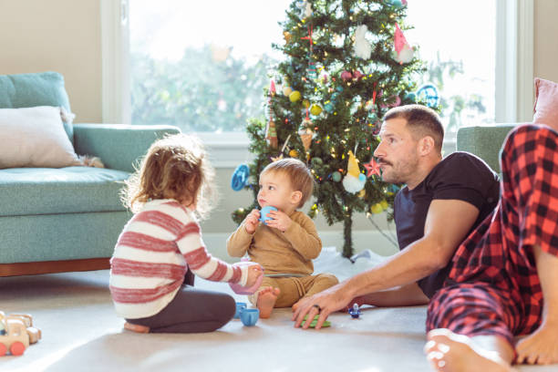 istock Siblings at home for Christmas having a tea party with their dad 2052335534