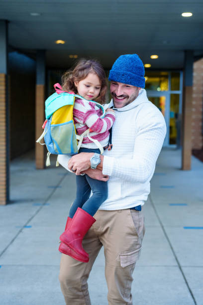 istock Loving dad saying goodbye to daughter before school 2052336092