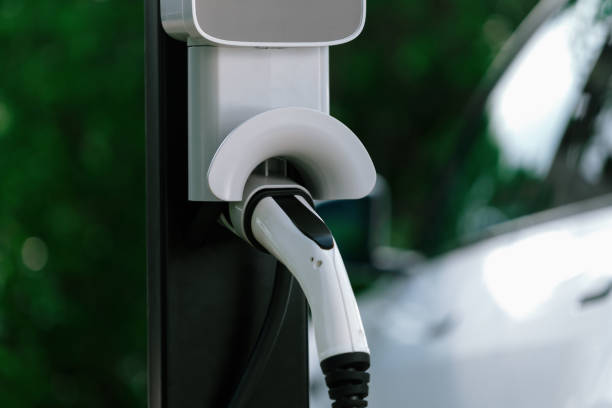 istock Closeup EV charging station with charger plug connected power sauce. Synchronos 2052351663