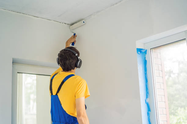 istock Professional painter worker painting and priming wall with painting roller 2052365771