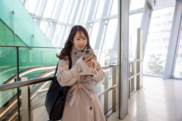 istock Business woman using smart phone in city 2052380439