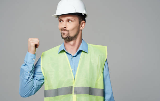 istock construction worker in white helmet and green reflective vest 2052396139