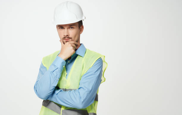 istock construction worker in white helmet and green reflective vest 2052400797