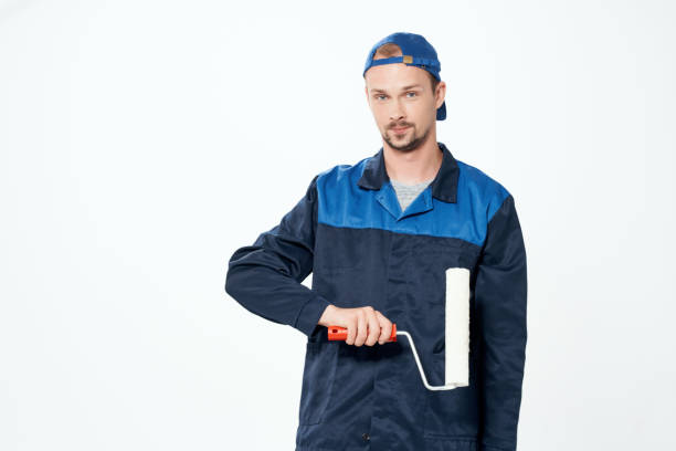 istock man in work uniform wall painting repair service 2052404419