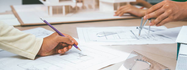istock Professional architect team select sustainable house materials. Variegated. 2052407525