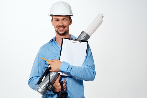 Cheerful man in construction uniform engineer work drawings professional. High quality photo