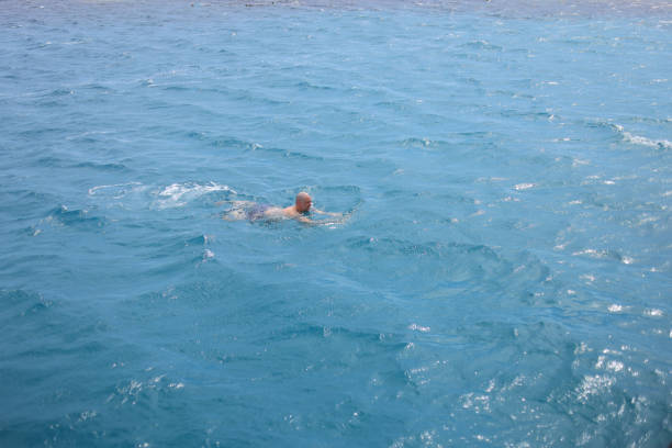 Swimmer training on the open sea ocean.