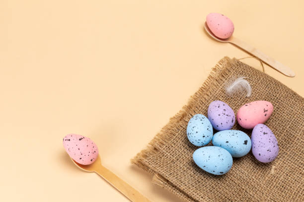 istock Colored Easter eggs on a sackcloth bag and wooden spoons. 2052444634