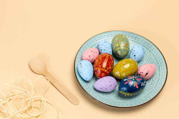 istock Easter eggs on a dish with a spoon on the beige background. 2052448862