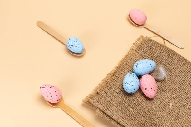 istock Colored Easter eggs on a sackcloth bag and wooden spoons. 2052459460