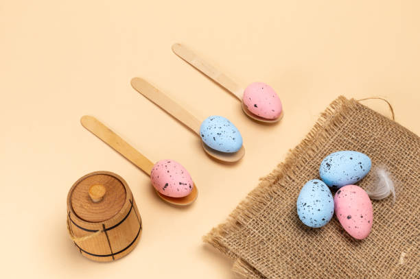 istock Colored Easter eggs on a sackcloth bag and wooden spoons. 2052459978