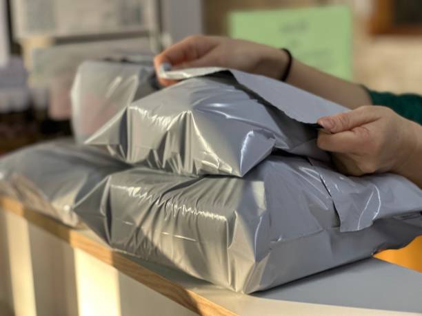 istock Packing the goods in a postal bag for shipping. 2052477467