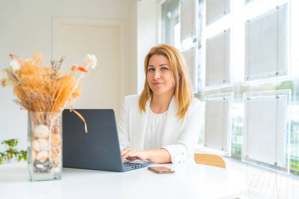 istock Real estate agent using laptop in her office 2052478013