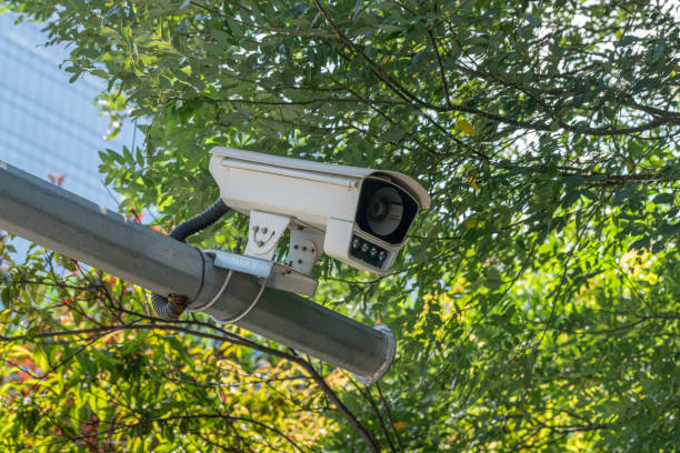 istock Surveillance camera and leaves background 2052481204