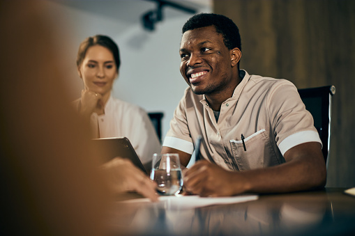 A male doctor signed a contract with a client from a big company, during the meeting.