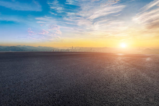 istock Empty asphalt road and mountains with city skyline background 2052487527