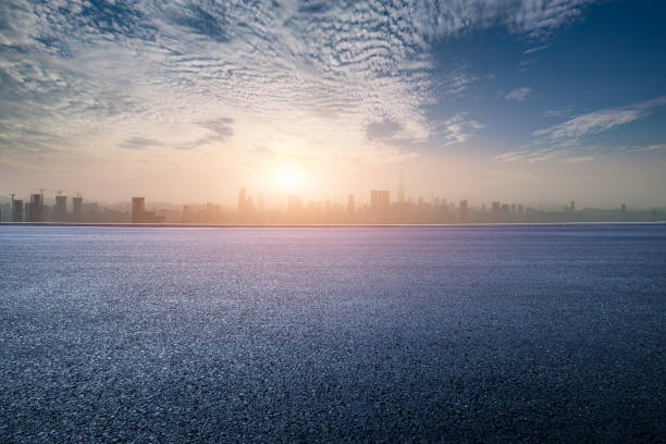 istock Empty asphalt road and mountains with city skyline background 2052487528