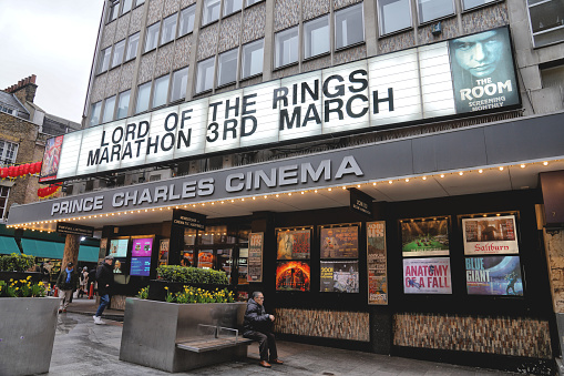 Leicester Place, London, WC2H 7BY, England - February 28th 2024: The marquee sign at The Prince Charles Cinema, a Cult Cinema, and the film screenings of director Peter Jackson's The Lord of the Rings (LOTR) trilogy, presents an all-day and night movie marathon. This film-house in London’s West End, a repertory independent cinema, resides, close to Leicester Square in England.\n\nAn exterior view of a state-of-the-art chain cinema building. \n\nThis state-of-the-art chain cinema advertises the film \
