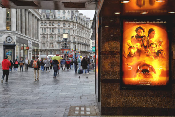 Empire - Cineworld IMAX Leicester Square Movie theatre in Central London, West End Cinema Building Exterior Advertises Denis Villeneuve "Dune 2 / Dune: Part Two" IMAX Film Poster Movie Theater Leicester Square in West End of London England UK Britain Cineworld Leicester Square in Leicester Square WC2H 7NA London, England - An exterior view of a state-of-the-art chain cinema building.  'Dune: Part Two' / 'Dune 2' movie poster, a 2024 epic science fiction film directed and co-produced by Denis Villeneuve, seen in the West End of London.

This state-of-the-art chain cinema advertises the IMAX film "Dune: Part Two" (Distributed by: Warner Bros. Pictures) starring Starring Timothée Chalamet, Zendaya (Zendaya Maree Stoermer Coleman), Rebecca Ferguson, Josh Brolin, Austin Butler, Florence Pugh, Dave Bautista, Christopher Walken, Léa Seydoux, Souheila Yacoub, Stellan Skarsgård, Charlotte Rampling, and Javier Bardem. showtime stock pictures, royalty-free photos & images