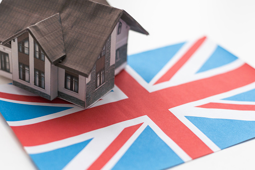 Small house on a flag - Living or migrating to United Kingdom. High quality photo