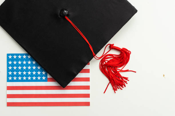 istock graduation hat on US flag, education concept 2052526009