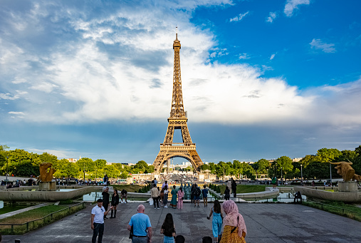 Paris, France - July 22 2022: Eiffel Tower from Champ de Mars with a lot of tourists
