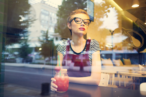 woman sitting in a cafe with a cocktail one lifestyle leisure. High quality photo