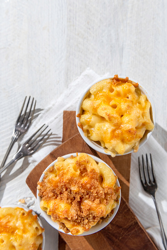Baked macaroni and cheese on a wihte rustic background