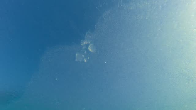 Underwater view of spring ice drift on flowing. Movement of thin ice on water surface