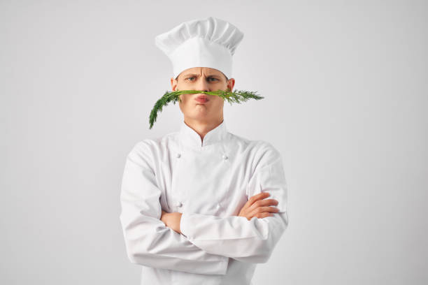istock chef with kitchen utensils greens near face restaurant 2052564285