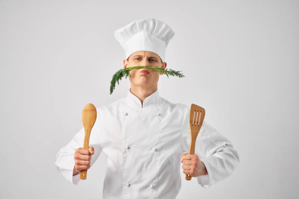 istock man chef's uniform nose green kitchen restaurant professional 2052576429
