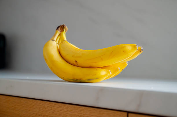 istock Banana positioned on the kitchen table, illuminated by daylight 2052584096