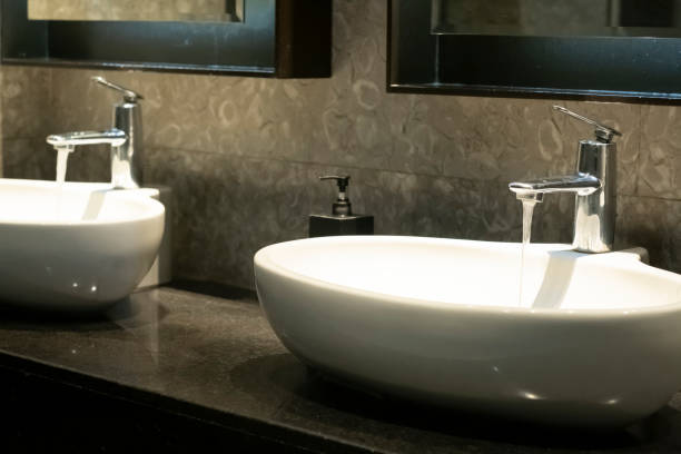 istock Two Bathroom Sink Basin and Open Chrome Faucet 2052586260