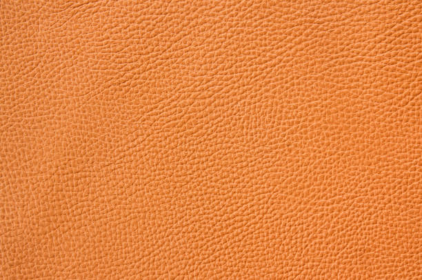 istock Texture of orange color leather sheet 2052593827