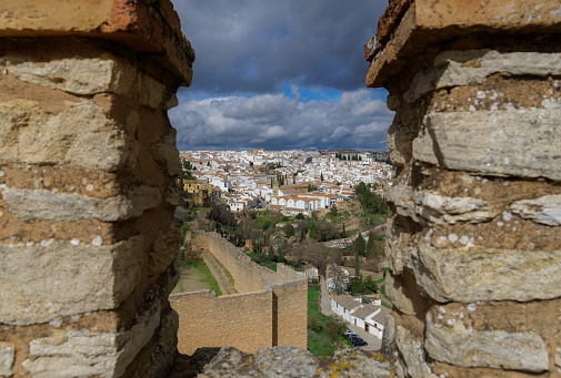 view of the city of ronda,malaga,spain from the city walls under a cloudy stormy sky