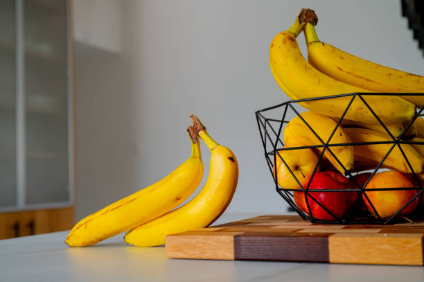 istock Banana on the kitchen counter, embraced by natural daylight 2052602380