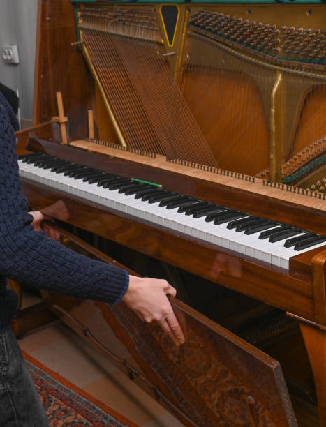 istock a man disassembles an old piano for repair 2052621044