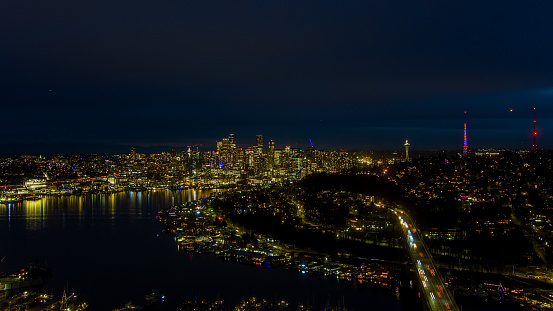 Drone shot of the Seattle, Washington skyline and Lake Union at night in December
