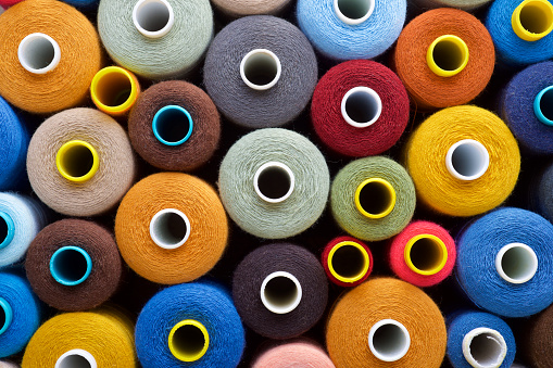 Close up of multicolored bobbins of sewing thread