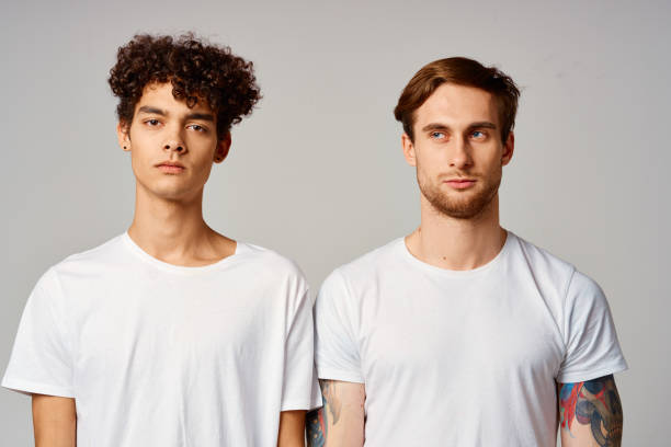 istock two friends in white t-shirts fun emotions isolated background 2052679480