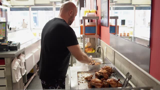 Man preparing a delivery in a rotisserie shop