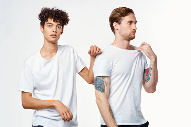 istock two men in white t-shirts stand side by side cropped view studio 2052683687