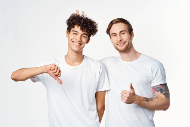istock two men in white t-shirts gesturing with their hands Friendship Studio 2052684725