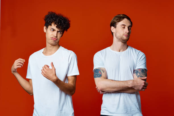 istock Two men in white t-shirts stand next to communication red background 2052686829