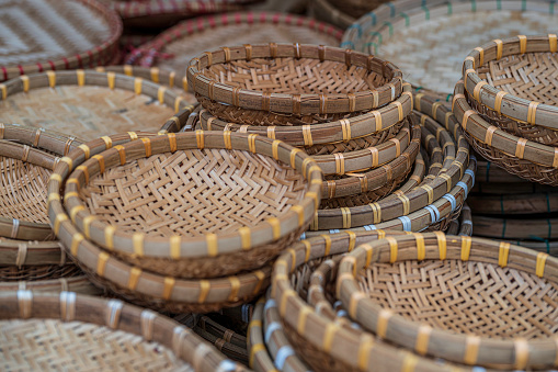 Close up view of multiple, traditional wicker baskets, for sale in a Vietnamese market