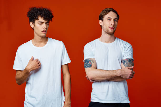 istock Two men in white t-shirts stand next to communication red background 2052693239