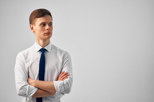 Portrait of young smiling businessman with arms crossed. Looking at camera. Copy space.