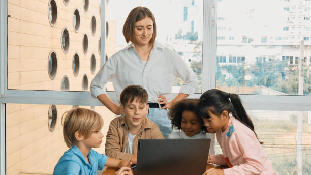 istock Cute girl programing system while surround with teacher and friend. Erudition. 2052747236
