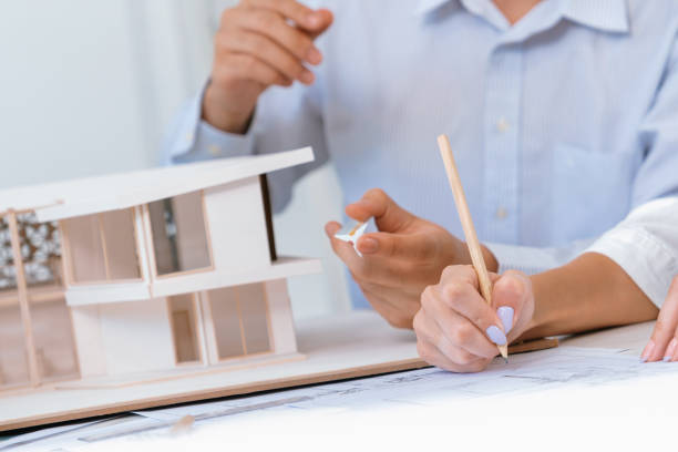 istock Closeup of engineer team working together to measure house model. Immaculate. 2052767757