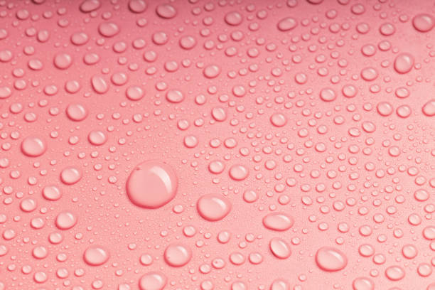 istock large drops of water and small ones on the pink surface are randomly arranged 2052798693